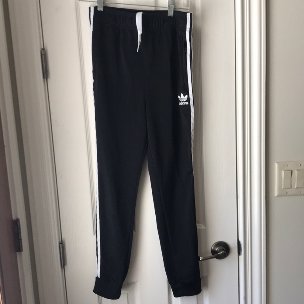 Adidas athletic pants. Youth large. Black with white stripes and stitched logo.
